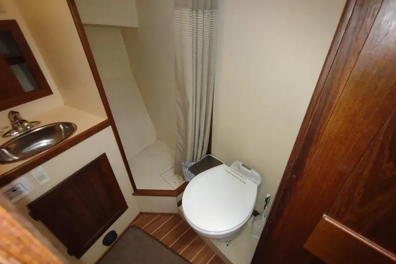 Dobro Yacht Photos Pics Bathroom interior of a 1990 Nordic Tug 32, featuring a toilet and sink.