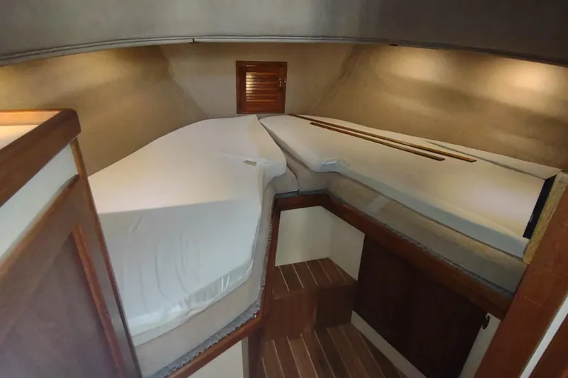 Dobro Yacht Photos Pics Cozy cabin interior of 1990 Nordic Tug 32 with wooden accents and bedding.