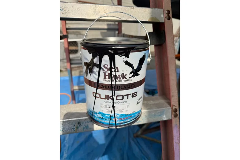 Dobro Yacht Photos Pics Paint can of Sea Hawk Cukote antifouling coating on ladder, Nordic Tug 32, 1990.