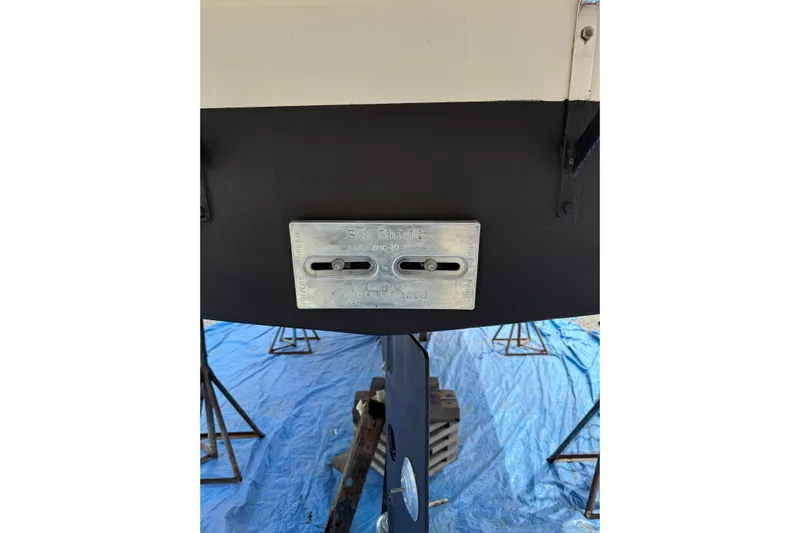 Dobro Yacht Photos Pics 1990 Nordic Tug 32 boat hull with zinc anode on blue tarp.