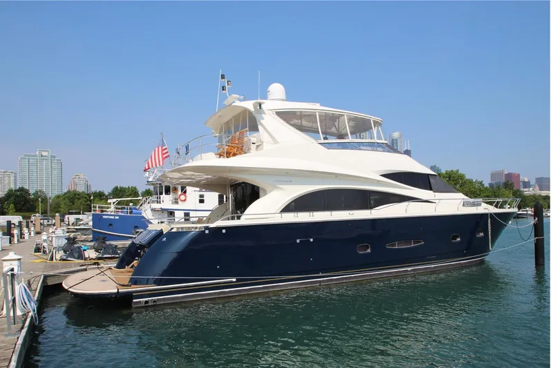 Bad Bettye Yacht Photos Pics Luxury 2006 Marquis 65 yacht docked at marina, featuring sleek design and spacious upper deck.