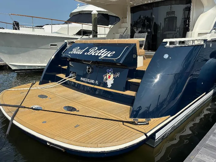 Bad Bettye Yacht Photos Pics Luxury 2006 Marquis 65 yacht docked, featuring sleek design and wooden deck.