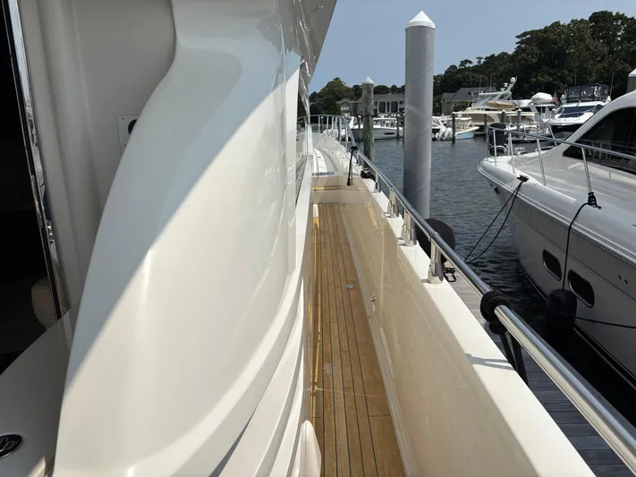 Bad Bettye Yacht Photos Pics Side deck of a 2006 Marquis 65 yacht docked at a marina.