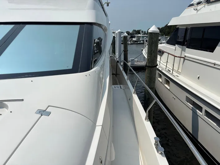 Bad Bettye Yacht Photos Pics Luxury Marquis 65 yacht docked at marina, 2006 model, sleek design, white exterior.