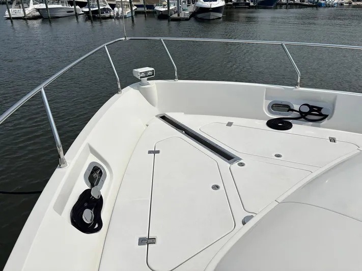 Bad Bettye Yacht Photos Pics Bow of 2006 Marquis 65 yacht docked at marina, featuring sleek design and railing.