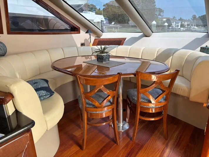 Bad Bettye Yacht Photos Pics Luxurious 2006 Marquis 65 yacht interior with elegant dining area and plush seating.