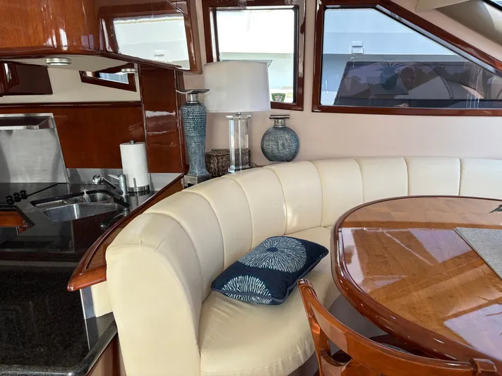 Bad Bettye Yacht Photos Pics Luxurious 2006 Marquis 65 yacht interior with elegant dining area and modern kitchen.