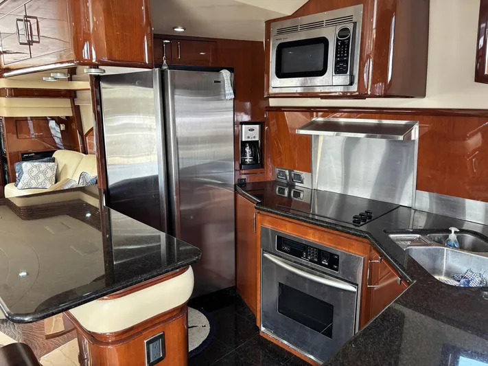 Bad Bettye Yacht Photos Pics Luxurious kitchen interior of a 2006 Marquis 65 yacht with modern appliances.