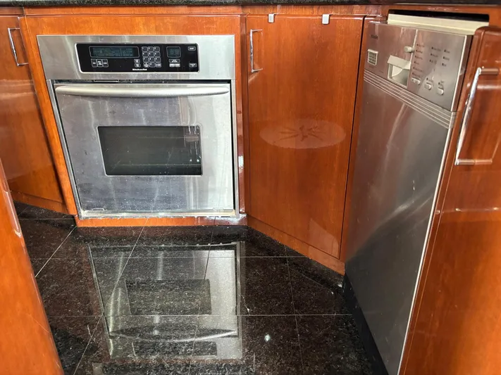 Bad Bettye Yacht Photos Pics Modern kitchen with stainless steel appliances and wooden cabinetry on a 2006 Marquis 65 yacht.