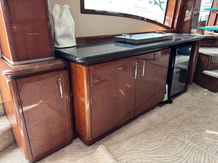 Bad Bettye Yacht Photos Pics Luxurious interior of a 2006 Marquis 65 yacht with polished wood cabinetry.