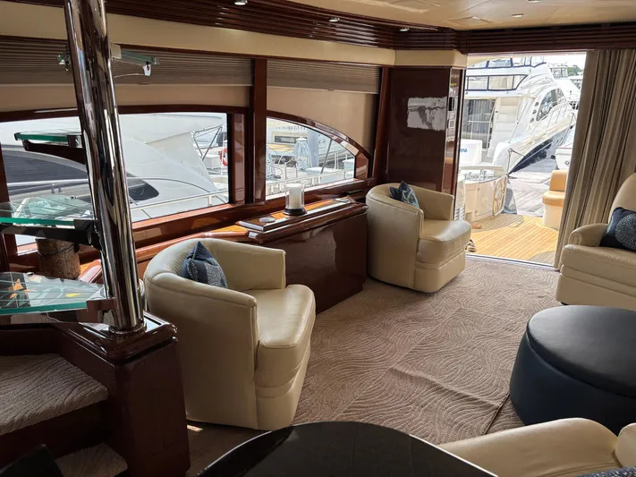 Bad Bettye Yacht Photos Pics Luxurious interior of a 2006 Marquis 65 yacht with elegant seating and large windows.