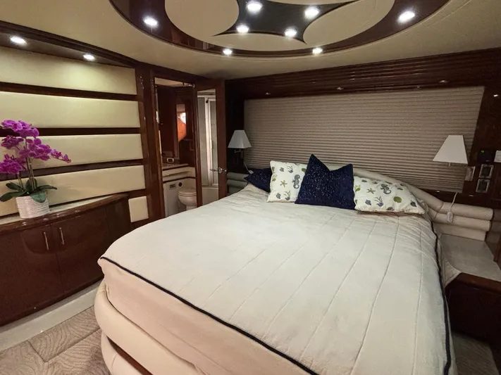 Bad Bettye Yacht Photos Pics Luxurious bedroom interior of 2006 Marquis 65 yacht with elegant decor and ambient lighting.