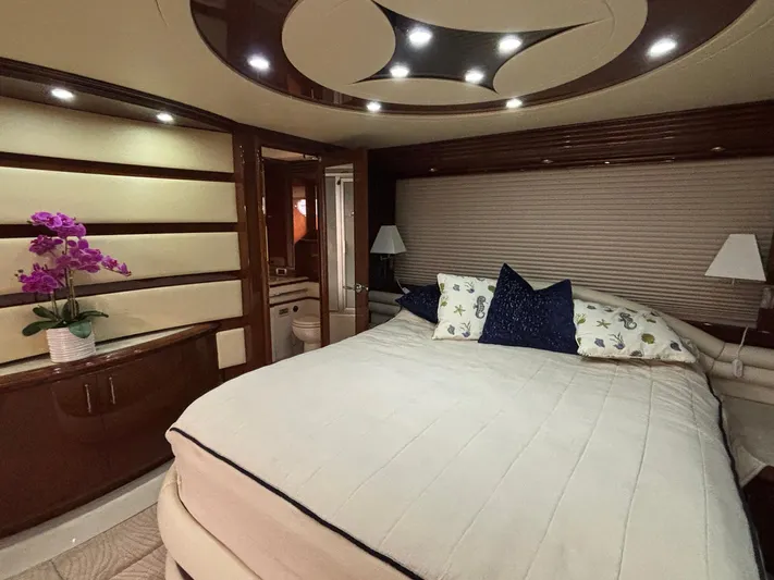Bad Bettye Yacht Photos Pics Luxurious bedroom interior of 2006 Marquis 65 yacht with elegant decor and ambient lighting.