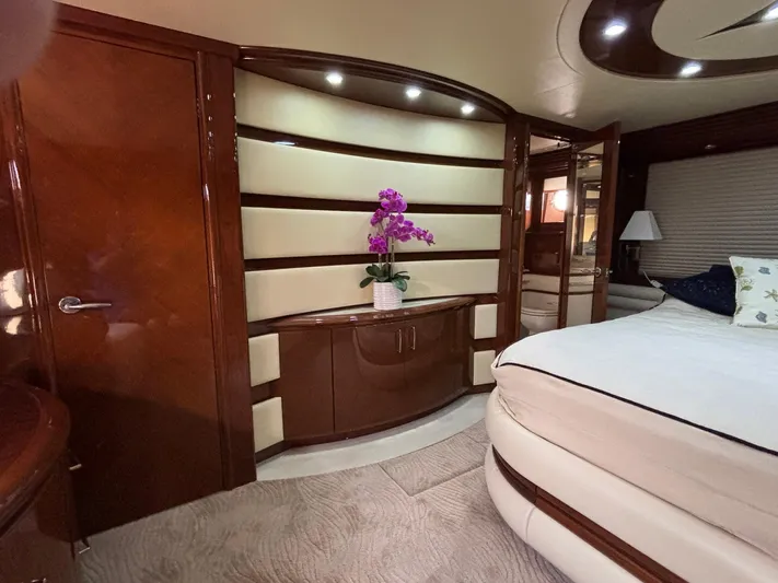 Bad Bettye Yacht Photos Pics Luxurious interior of a 2006 Marquis 65 yacht with elegant wood finishes and floral decor.