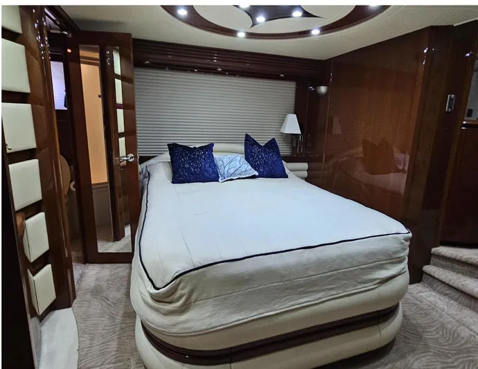 Bad Bettye Yacht Photos Pics Luxurious bedroom interior of 2006 Marquis 65 yacht with elegant bedding and ambient lighting.