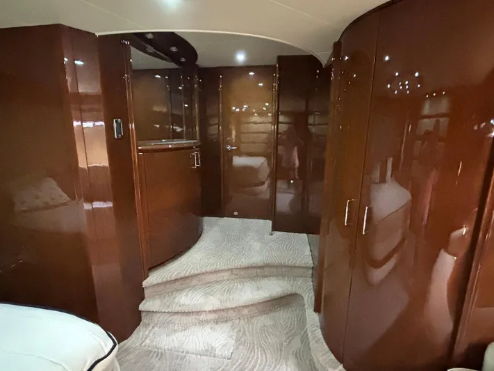 Bad Bettye Yacht Photos Pics Luxurious interior of a 2006 Marquis 65 yacht with glossy wood finishes.