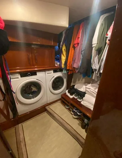 Bad Bettye Yacht Photos Pics Laundry room with washer, dryer, and clothes in a 2006 Marquis 65 yacht.