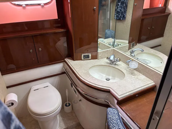Bad Bettye Yacht Photos Pics Luxurious bathroom in 2006 Marquis 65 yacht with elegant wood cabinetry and modern fixtures.
