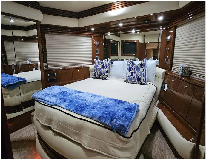 Bad Bettye Yacht Photos Pics Luxurious bedroom interior of 2006 Marquis 65 yacht with elegant bedding and wood finishes.