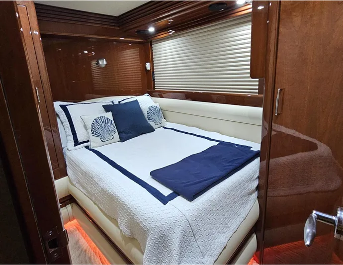 Bad Bettye Yacht Photos Pics Luxurious bedroom interior of 2006 Marquis 65 yacht with elegant bedding and wood paneling.