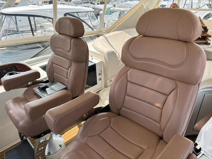Bad Bettye Yacht Photos Pics Luxurious leather seats on a 2006 Marquis 65 yacht, showcasing comfort and style.