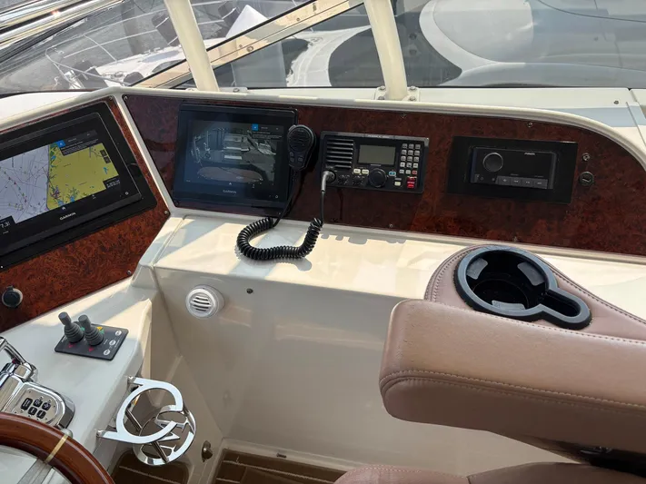 Bad Bettye Yacht Photos Pics Control panel of a 2006 Marquis 65 yacht with navigation and communication equipment.