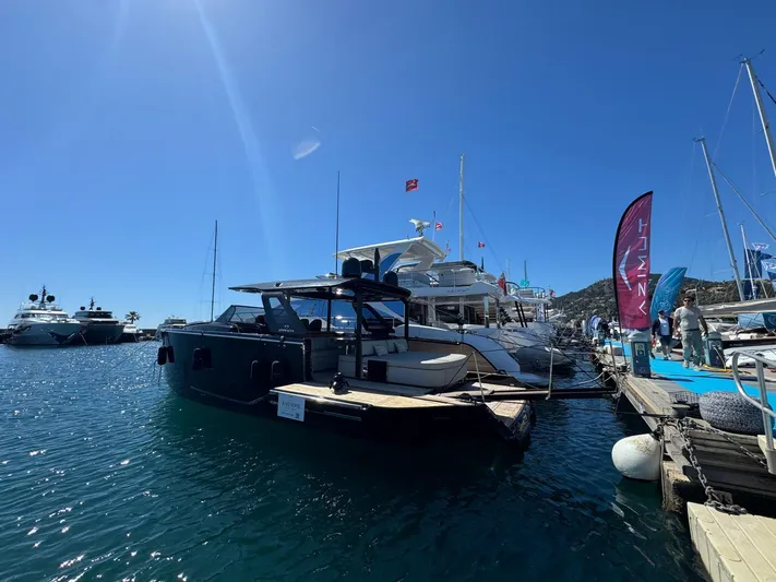  Yacht Photos Pics 2024 Cranchi A46 Luxury Tender docked at a marina under clear blue skies.