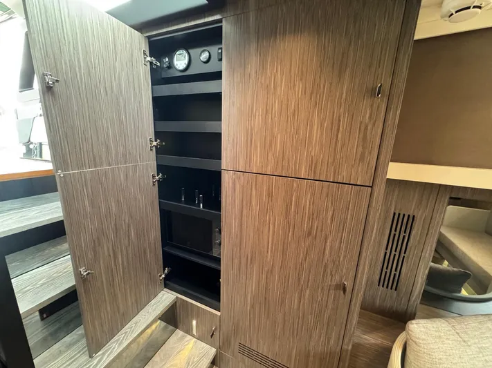  Yacht Photos Pics 2024 Cranchi A46 Luxury Tender interior with open wooden cabinet and modern design elements.