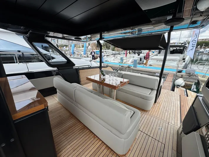  Yacht Photos Pics 2024 Cranchi A46 Luxury Tender with elegant seating and wooden deck at a marina.