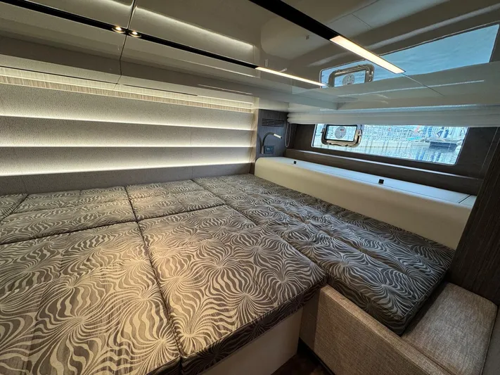  Yacht Photos Pics 2024 Cranchi A46 Luxury Tender cabin with modern design and patterned bedding.
