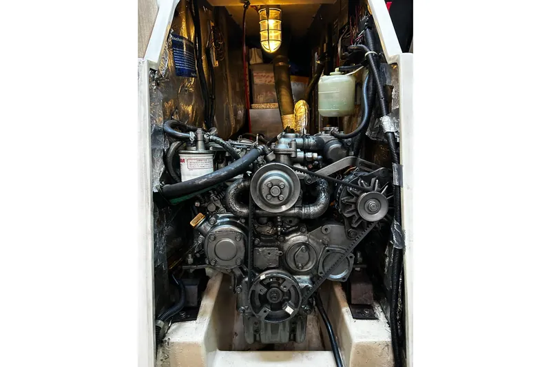 Simpatico Yacht Photos Pics Engine compartment of a 1999 Catalina 42 MkII sailboat, featuring mechanical components and wiring.