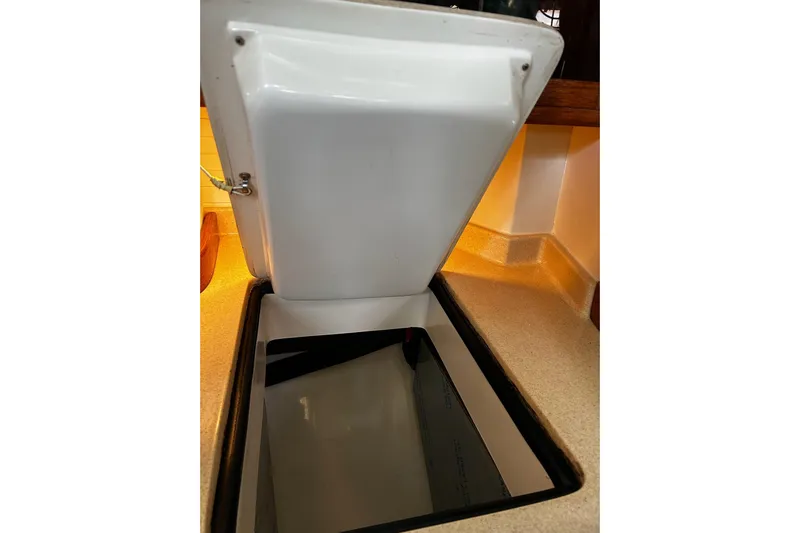 Simpatico Yacht Photos Pics Open storage compartment on 1999 Catalina 42 MkII yacht, showcasing interior space.