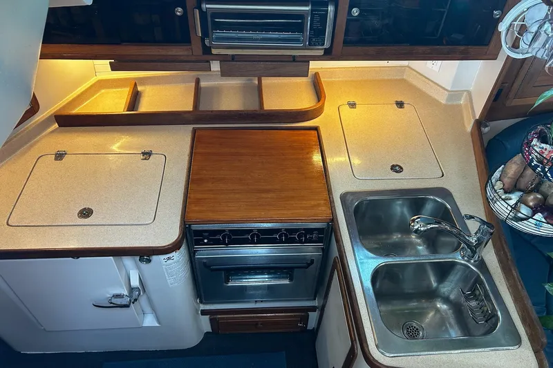 Simpatico Yacht Photos Pics 1999 Catalina 42 MkII yacht kitchen with stove, dual sink, and ample counter space.