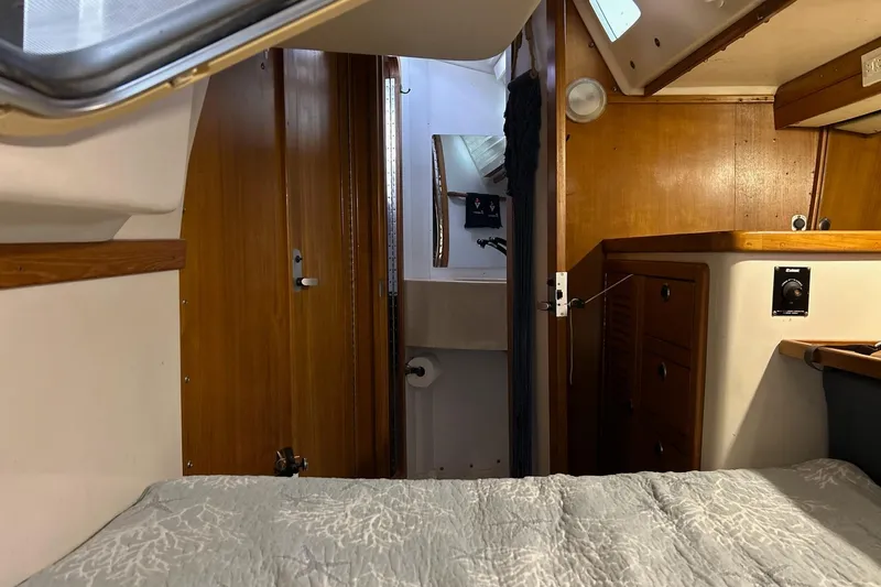 Simpatico Yacht Photos Pics Interior of a 1999 Catalina 42 MkII sailboat, featuring wood paneling and a cozy cabin.