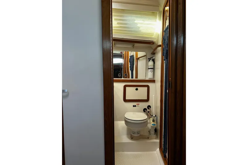 Simpatico Yacht Photos Pics Bathroom interior of 1999 Catalina 42 MkII yacht, featuring compact design and wooden accents.
