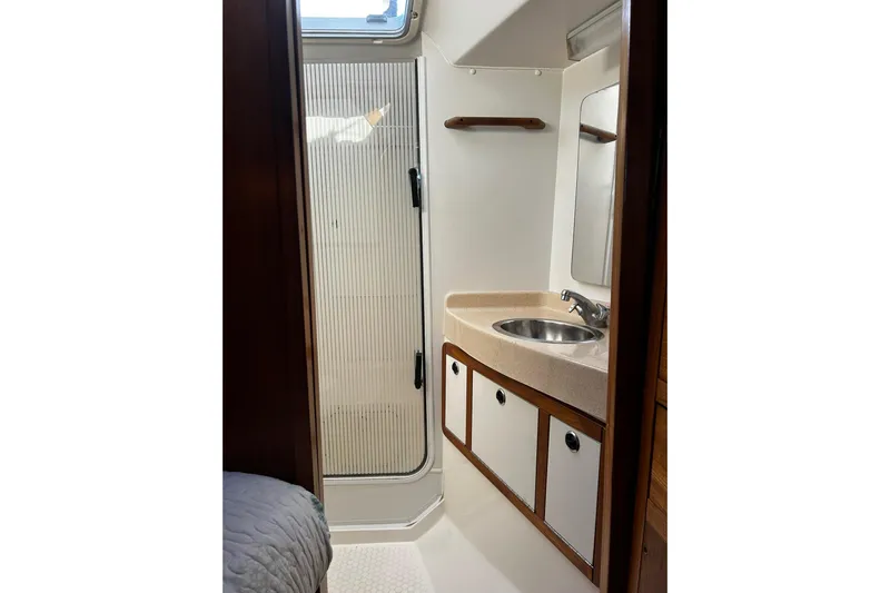 Simpatico Yacht Photos Pics Bathroom interior of 1999 Catalina 42 MkII sailboat with sink and shower.