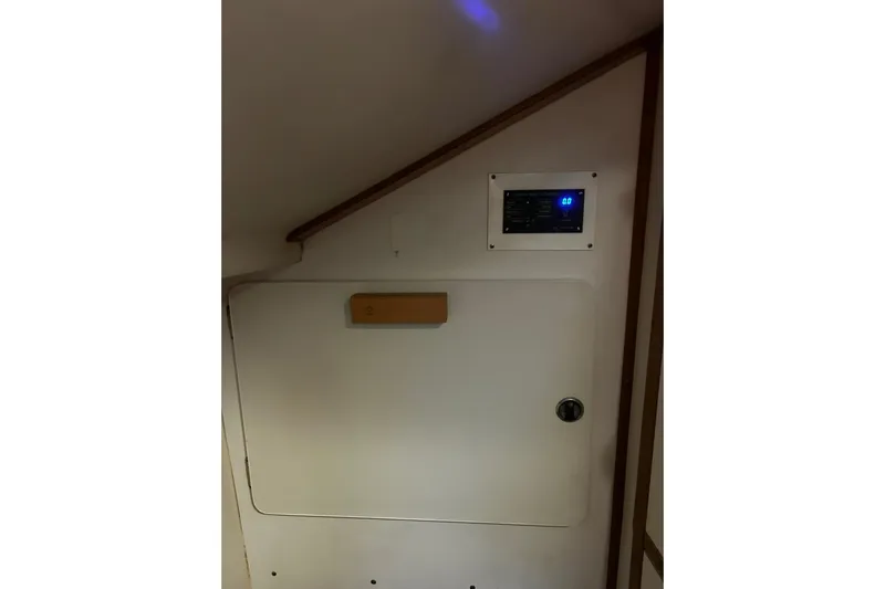 Simpatico Yacht Photos Pics Interior of 1999 Catalina 42 MkII sailboat with control panel and storage compartment.