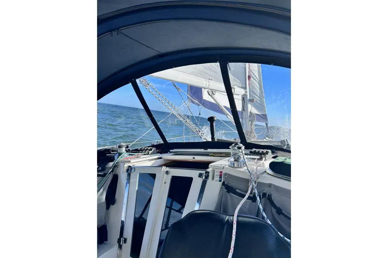 Simpatico Yacht Photos Pics Sailing view from 1999 Catalina 42 MkII cockpit, open sea and sails visible.