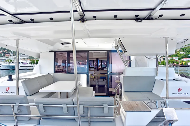 Boomerang Yacht Photos Pics 2022 Fountaine Pajot Astrea 42 catamaran interior with modern seating and dining area.