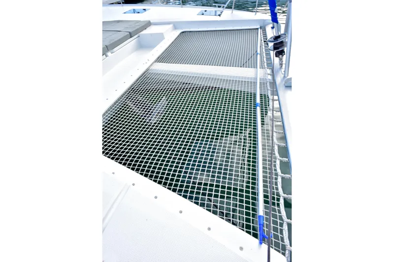 Boomerang Yacht Photos Pics Fountaine Pajot Astrea 42 catamaran netting, 2022 model, over clear water.