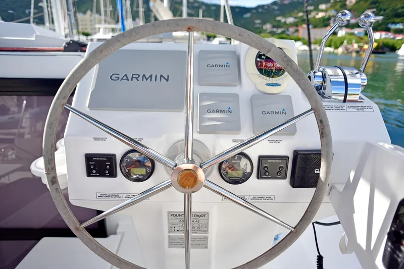 Boomerang Yacht Photos Pics Steering wheel and controls of 2022 Fountaine Pajot Astrea 42 catamaran with Garmin navigation.