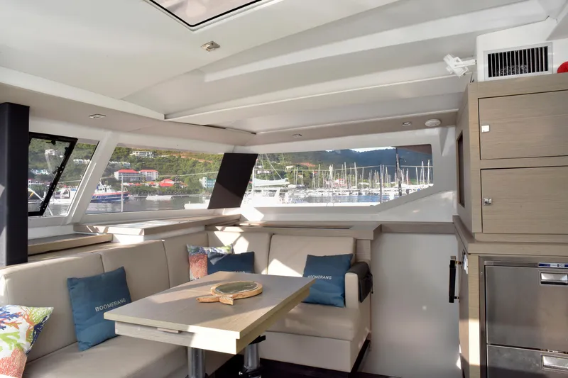 Boomerang Yacht Photos Pics Luxurious interior of 2022 Fountaine Pajot Astrea 42 catamaran with marina view.