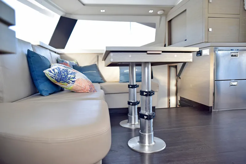 Boomerang Yacht Photos Pics Luxurious interior of 2022 Fountaine Pajot Astrea 42 catamaran with modern seating and table.