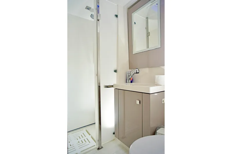 Boomerang Yacht Photos Pics Bathroom interior of 2022 Fountaine Pajot Astrea 42 yacht, featuring modern sink and shower.
