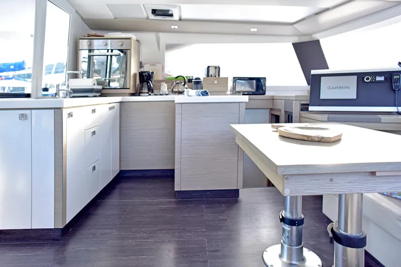 Boomerang Yacht Photos Pics Modern kitchen interior of 2022 Fountaine Pajot Astrea 42 catamaran with sleek appliances.