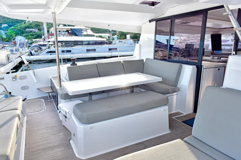 Boomerang Yacht Photos Pics Luxurious 2022 Fountaine Pajot Astrea 42 yacht interior with elegant seating and dining area.