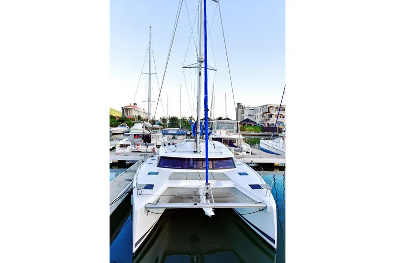 Boomerang Yacht Photos Pics 2022 Fountaine Pajot Astrea 42 catamaran docked in a marina.