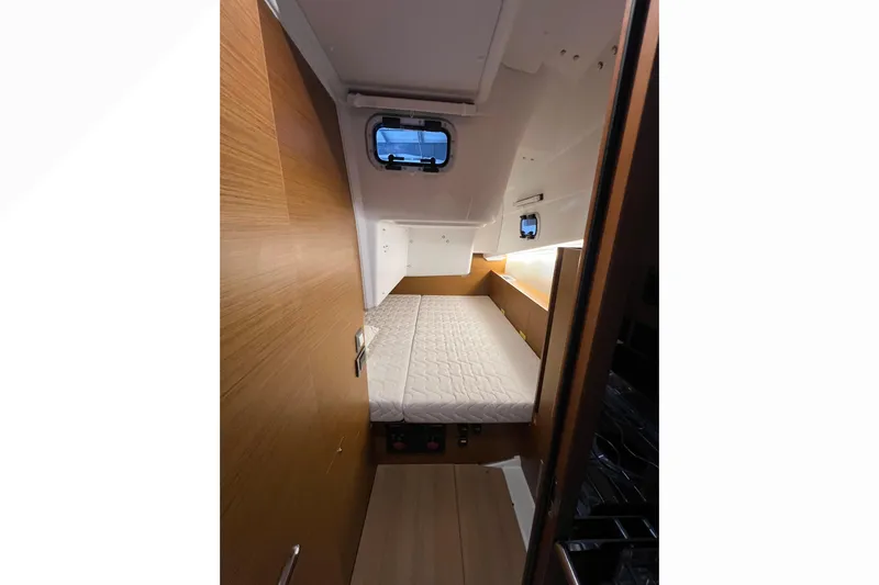 Job Site Yacht Photos Pics 2023 Jeanneau Sun Odyssey 380 cabin interior with bed and wooden finish.