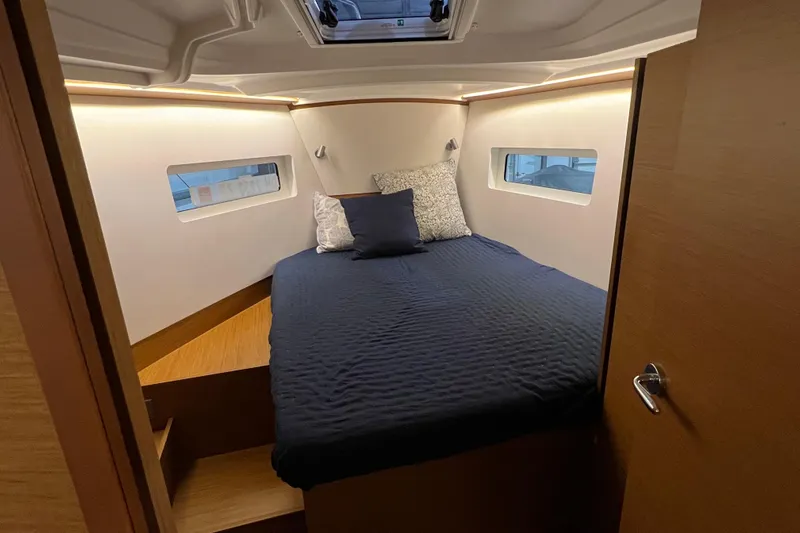 Job Site Yacht Photos Pics 2023 Jeanneau Sun Odyssey 380 cabin interior with cozy bed and modern design.