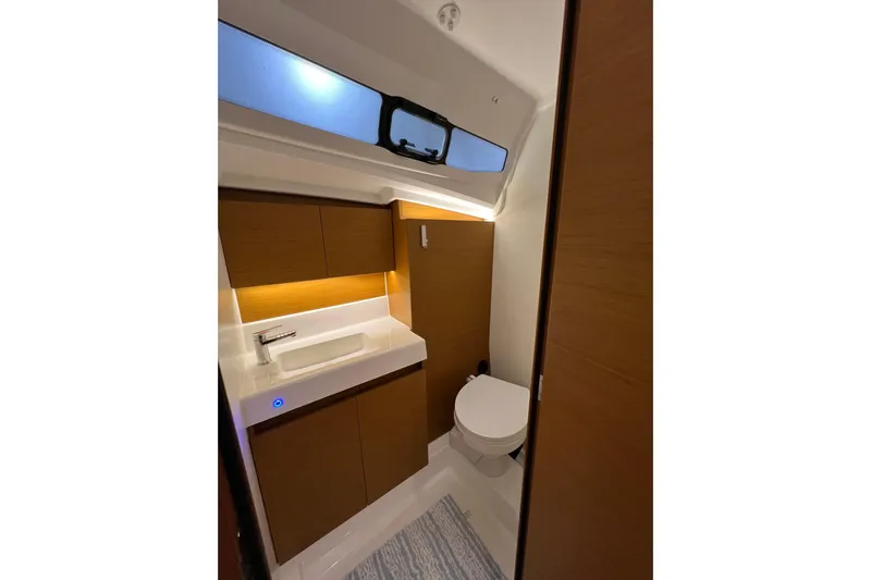 Job Site Yacht Photos Pics Modern bathroom interior of 2023 Jeanneau Sun Odyssey 380 yacht, featuring sleek design and wood accents.